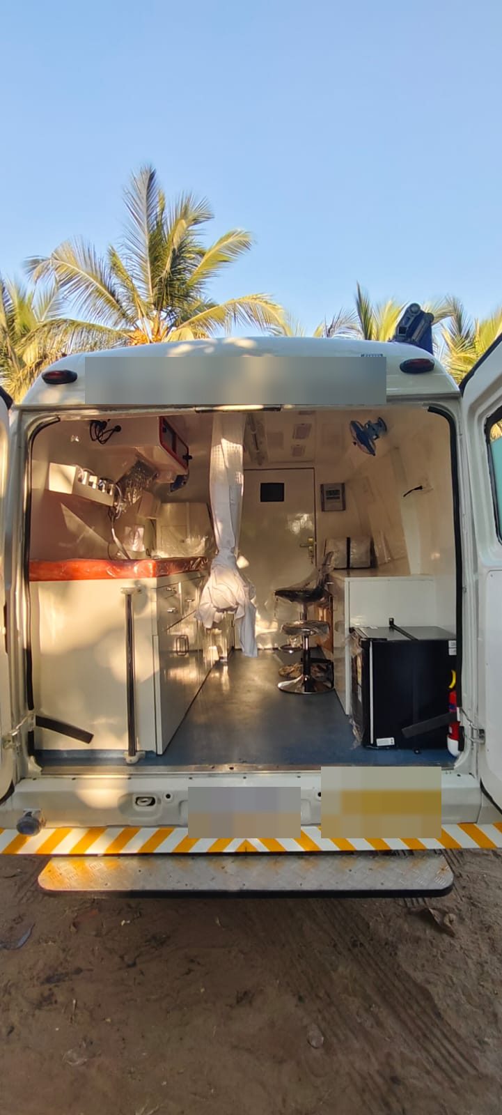 Mobile medical van at handover with rear doors open on site