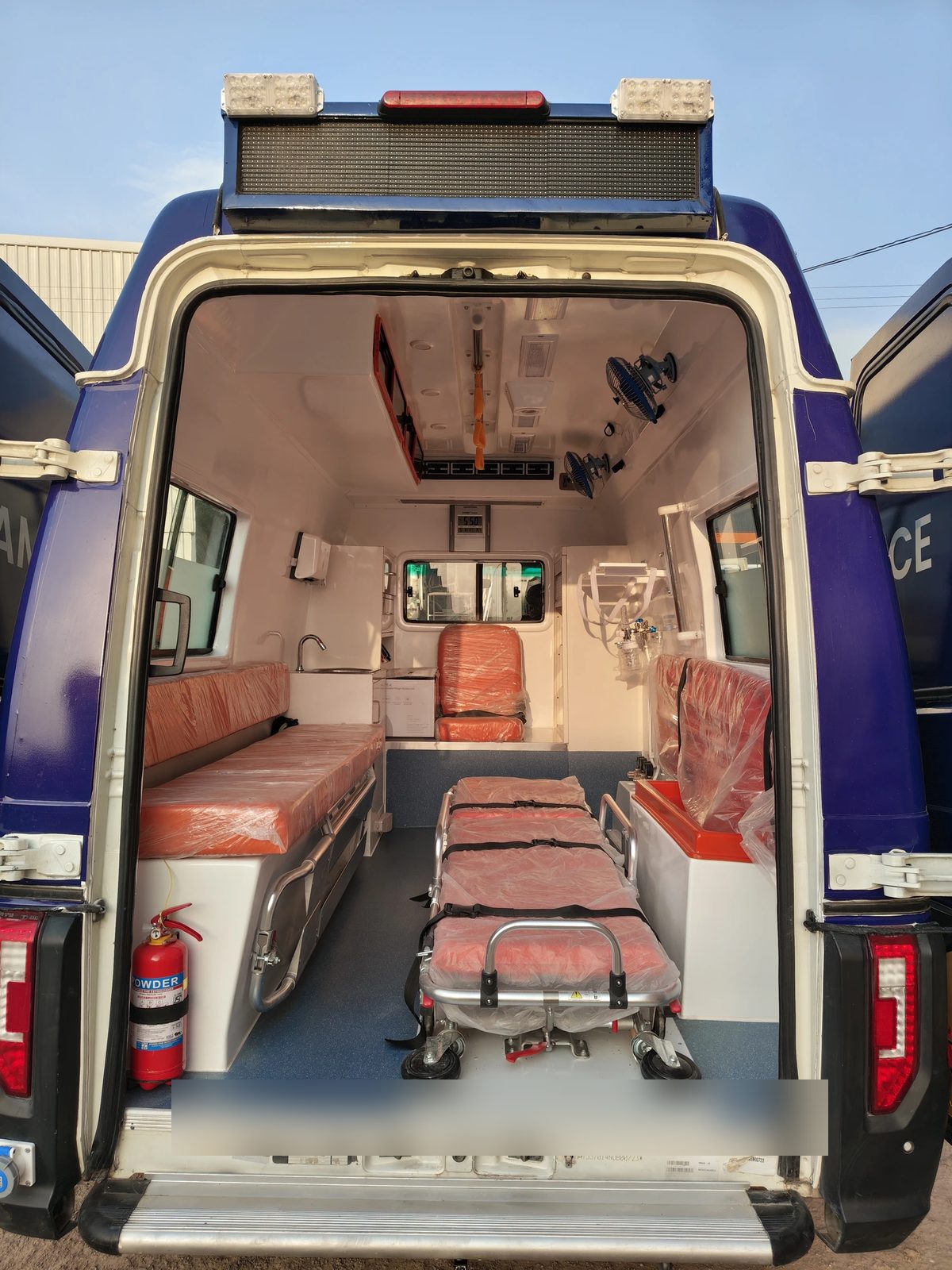Ambulance interior with stretcher, attendant bench and oxygen mounting